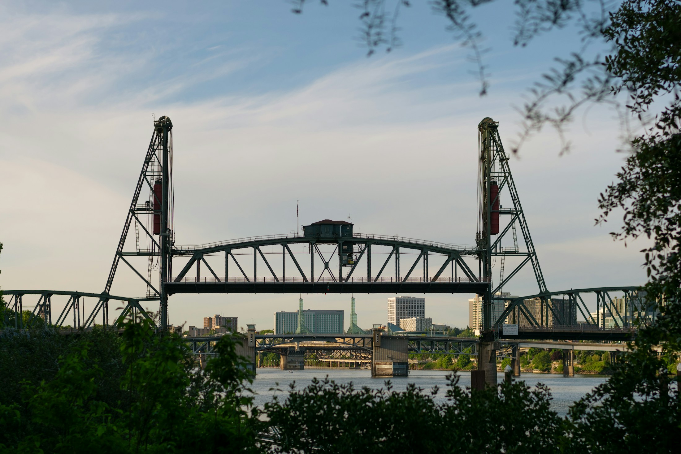 A raised bridge over Portland’s Willamette River in soft evening light